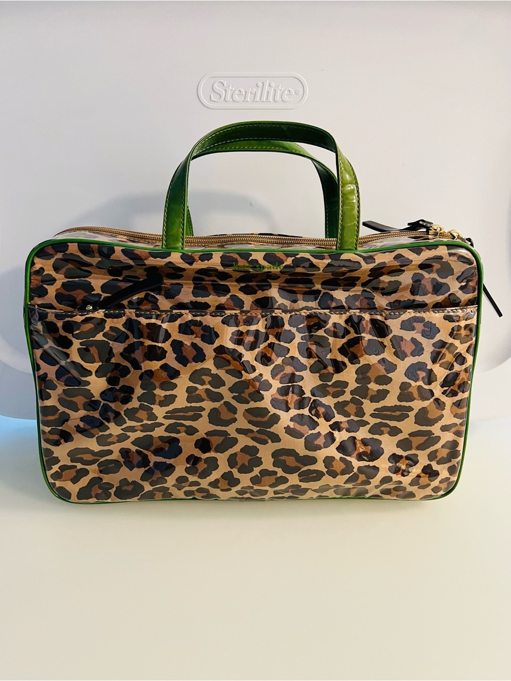 Brand new. Large Kate Spade cosmetic bag. Leopard print with green lining/trim.